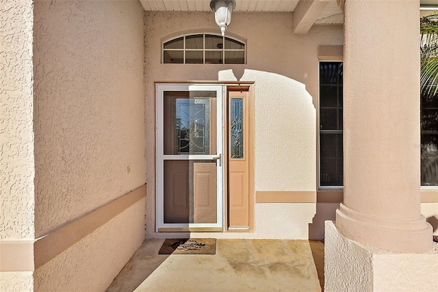 property entrance with stucco siding