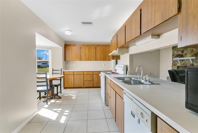 kitchen featuring visible vents, light countertops, light tile patterned flooring, white appliances, and a sink