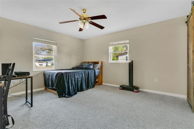 carpeted bedroom with baseboards and ceiling fan