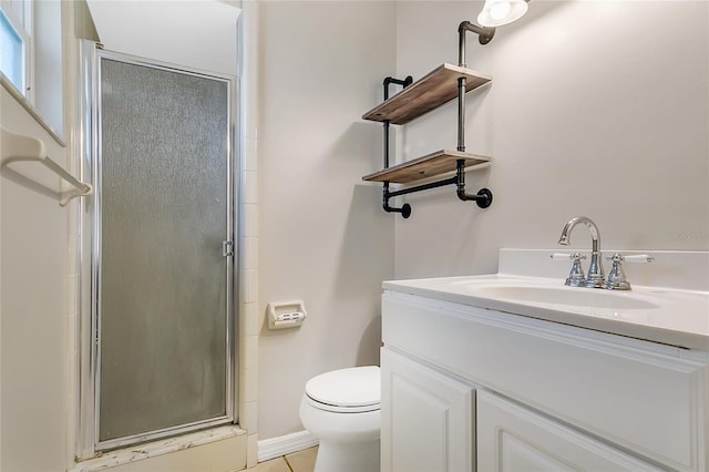 full bath featuring a stall shower, toilet, vanity, and baseboards