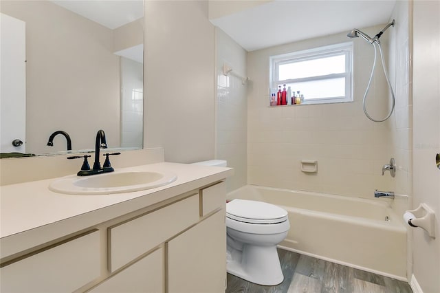 full bath with vanity,  shower combination, toilet, and wood finished floors