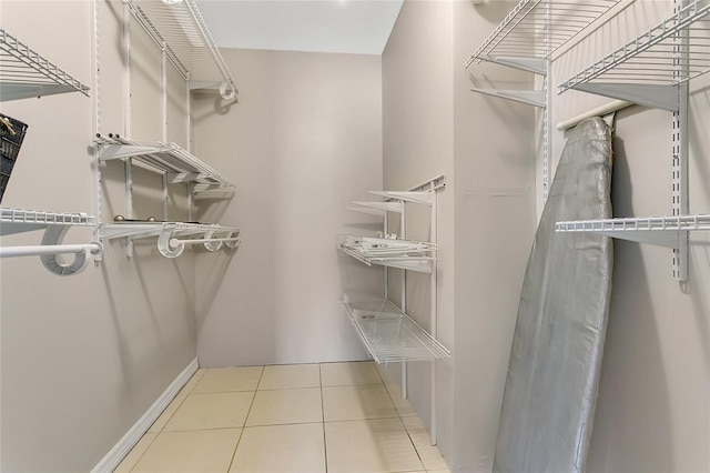 spacious closet with tile patterned floors