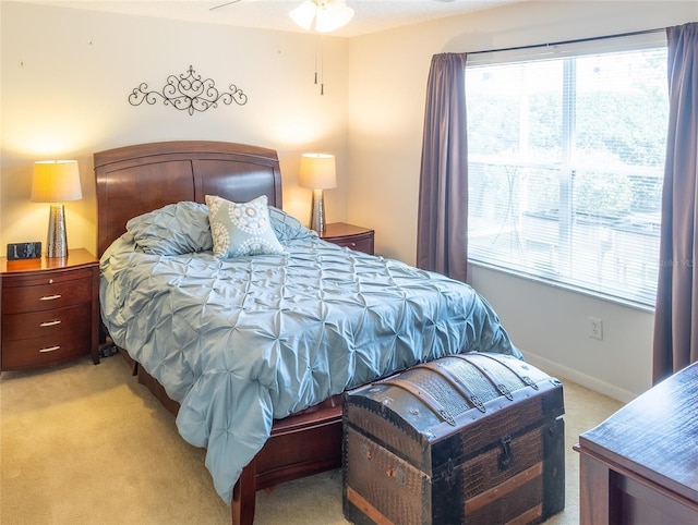 bedroom featuring baseboards and light colored carpet