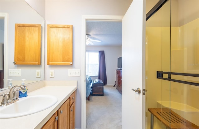 ensuite bathroom featuring a shower, a textured ceiling, ensuite bath, and vanity