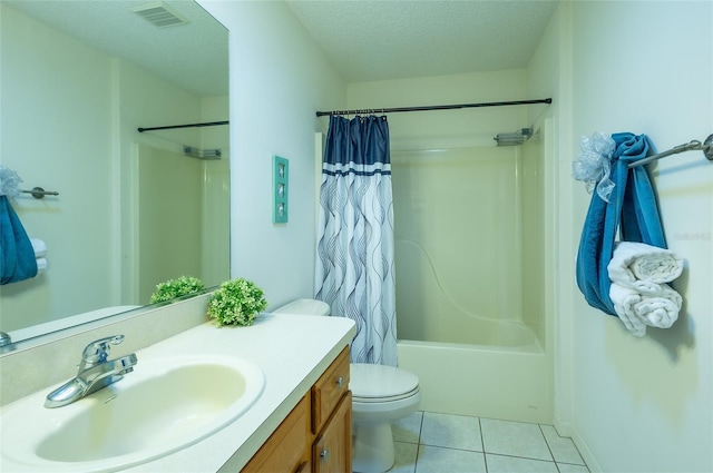 bathroom featuring visible vents, toilet, a textured ceiling, vanity, and tile patterned floors