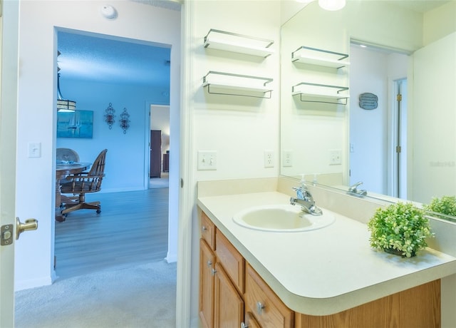 bathroom featuring baseboards and vanity