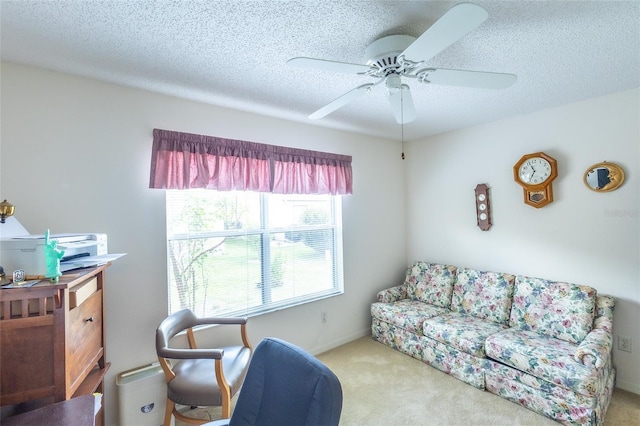 carpeted living room with ceiling fan and a textured ceiling