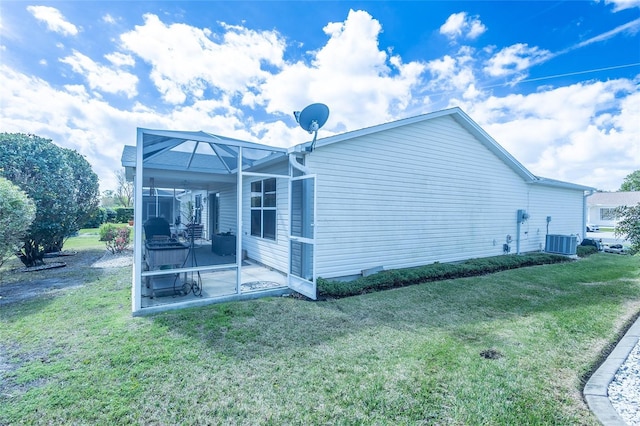 view of home's exterior featuring a patio area, a lawn, and central AC