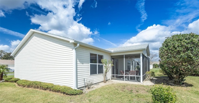 view of property exterior featuring a yard and a sunroom