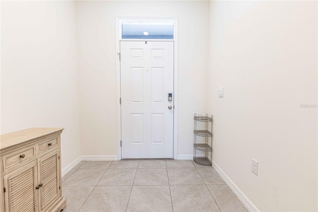 entrance foyer with baseboards and light tile patterned floors