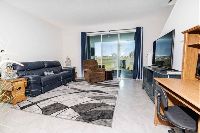 living area featuring light tile patterned floors and a textured ceiling