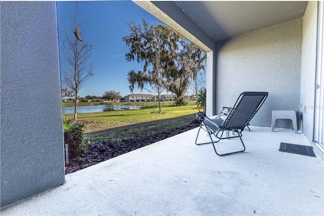 view of patio with a water view