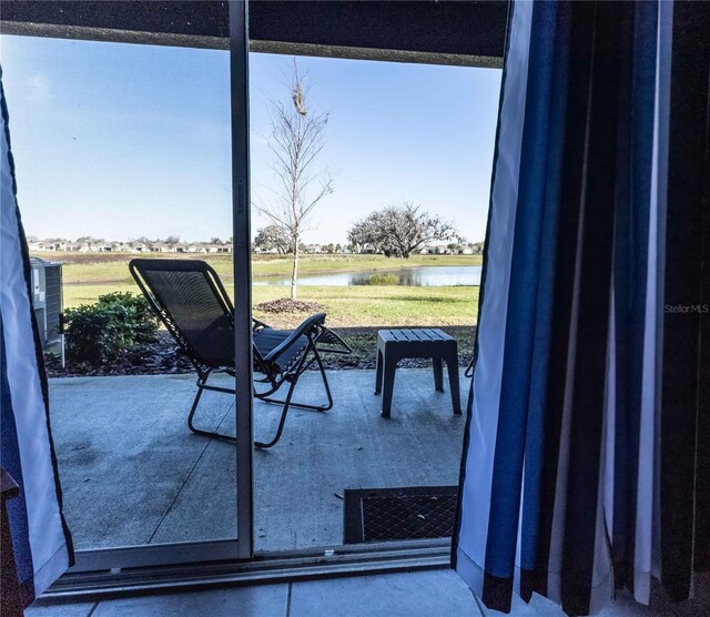 interior space with a wealth of natural light and a water view