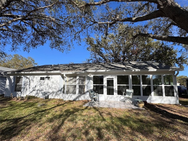 back of house with a patio, a lawn, and a sunroom