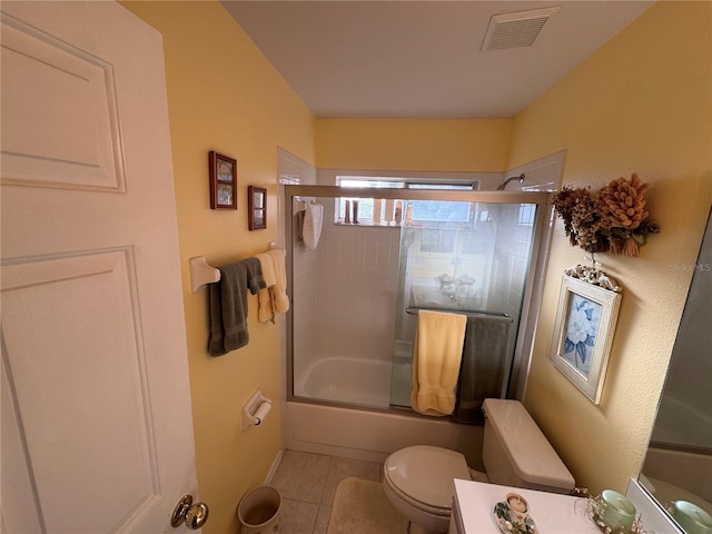 full bathroom featuring enclosed tub / shower combo, tile patterned flooring, toilet, vanity, and visible vents