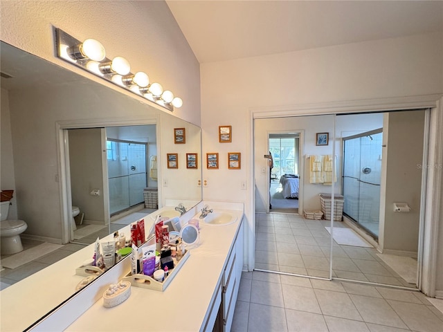 ensuite bathroom featuring tile patterned flooring, toilet, visible vents, vanity, and a shower stall