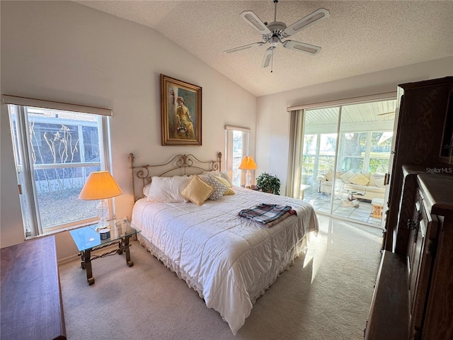 bedroom with vaulted ceiling, a textured ceiling, light colored carpet, and access to exterior