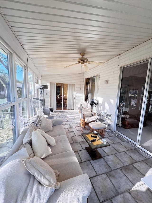 sunroom featuring a ceiling fan