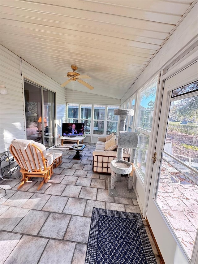 sunroom with lofted ceiling and a ceiling fan