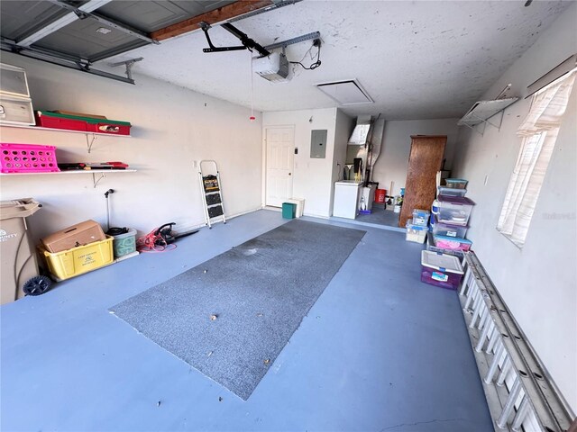 garage with a garage door opener and electric panel