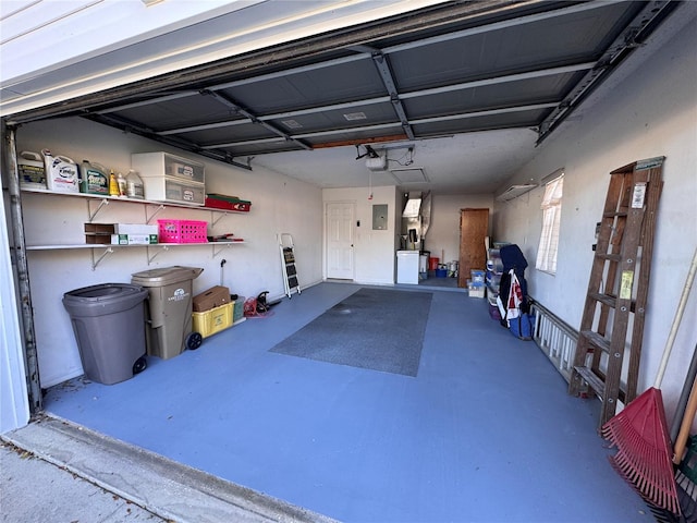 garage featuring electric panel and a garage door opener