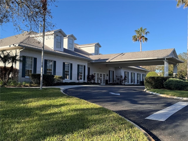 view of building exterior with aphalt driveway