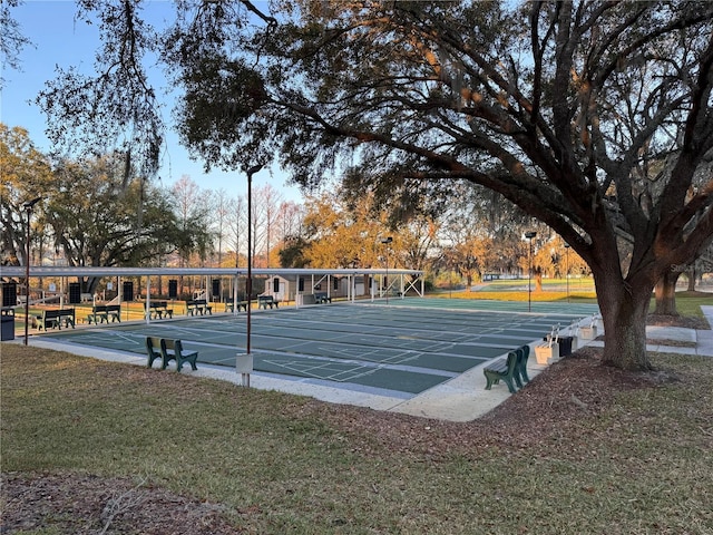 view of home's community featuring shuffleboard and a yard