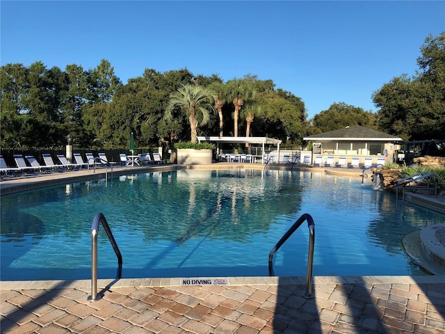 pool featuring fence and a patio