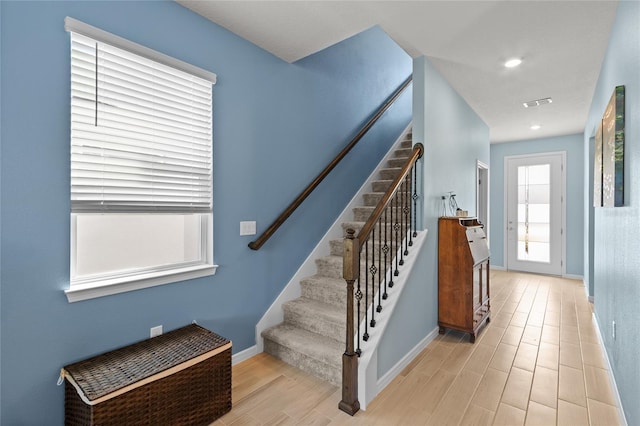 stairs featuring visible vents, baseboards, wood finished floors, and recessed lighting