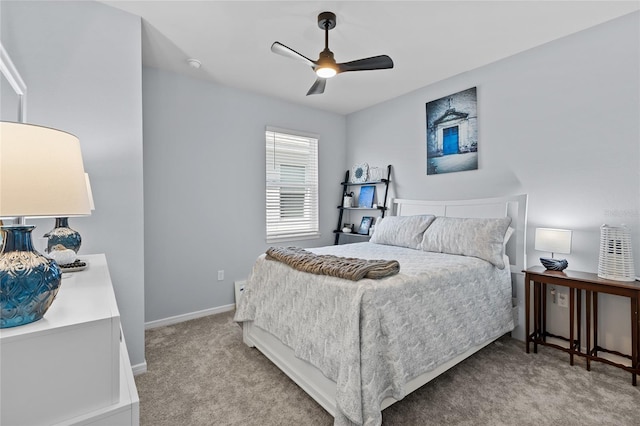 bedroom with ceiling fan, baseboards, and light colored carpet