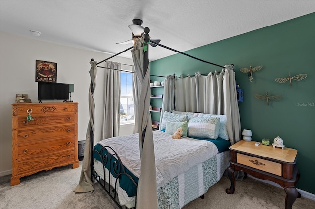 carpeted bedroom with ceiling fan and baseboards