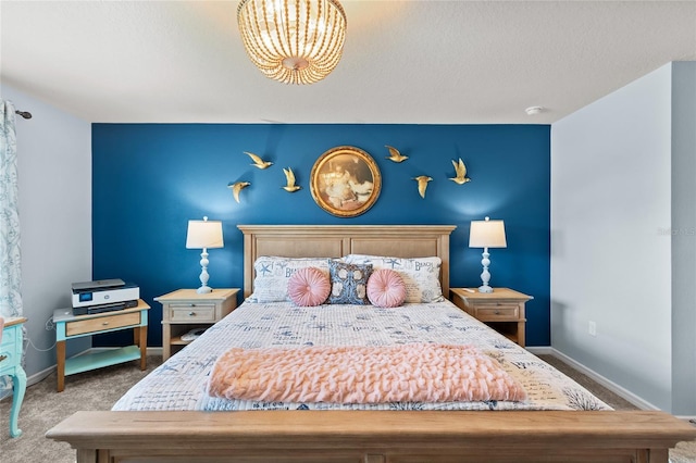 carpeted bedroom featuring baseboards and a textured ceiling