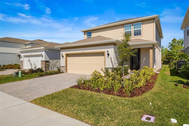 view of front facade with a front lawn, decorative driveway, an attached garage, and stucco siding