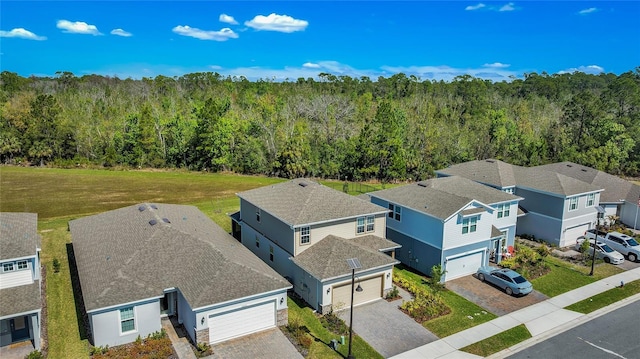 aerial view featuring a forest view and a residential view