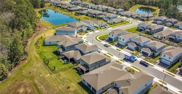 drone / aerial view with a residential view and a water view