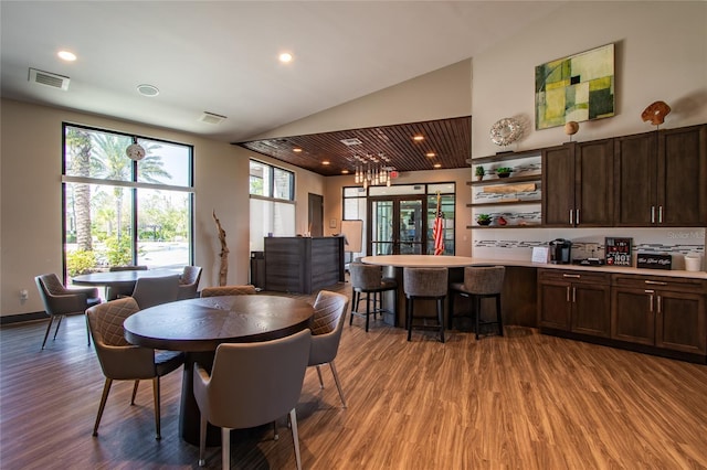 dining room featuring light wood-type flooring, high vaulted ceiling, visible vents, and recessed lighting