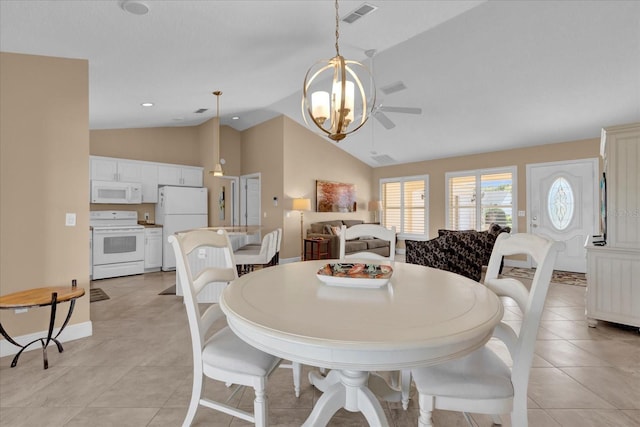 dining room featuring ceiling fan, visible vents, vaulted ceiling, and light tile patterned floors