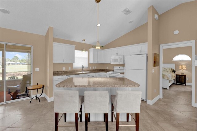 kitchen with white appliances, visible vents, a sink, and a healthy amount of sunlight