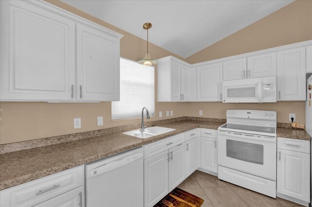 kitchen with white appliances, light tile patterned flooring, a sink, and white cabinets