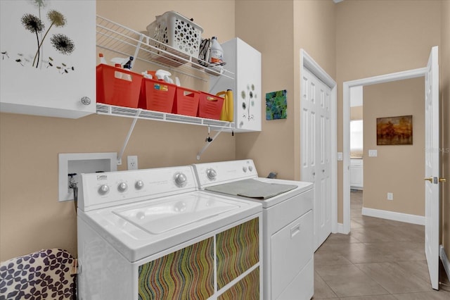 clothes washing area featuring laundry area, baseboards, washer and dryer, and tile patterned floors