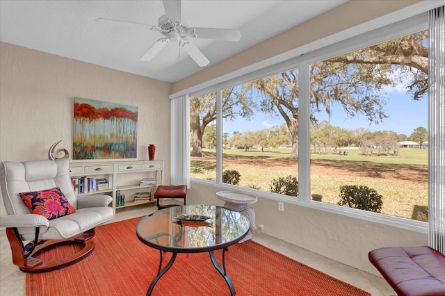 sunroom featuring ceiling fan