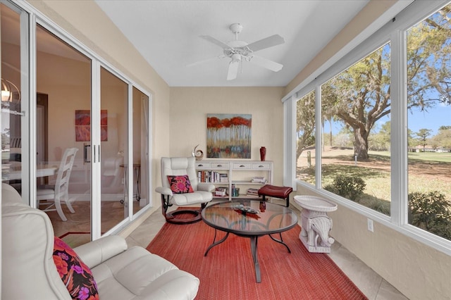 sunroom / solarium featuring ceiling fan and french doors