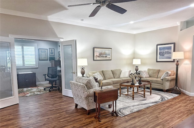 living area with wood finished floors, a ceiling fan, baseboards, french doors, and crown molding