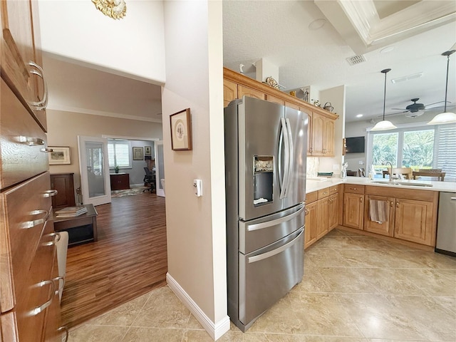 kitchen with crown molding, light countertops, visible vents, appliances with stainless steel finishes, and a sink