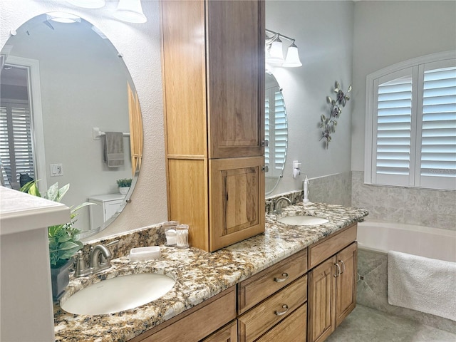 full bath featuring a garden tub, a sink, and double vanity