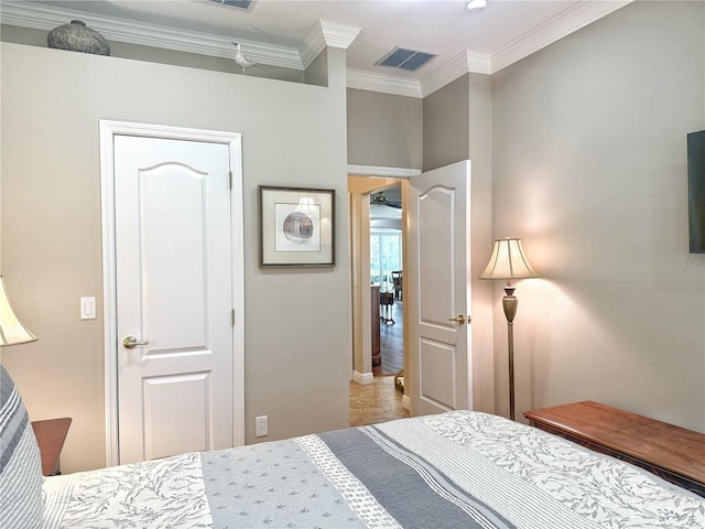 bedroom with ornamental molding and visible vents