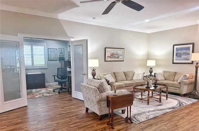 living room with ceiling fan, crown molding, and wood finished floors