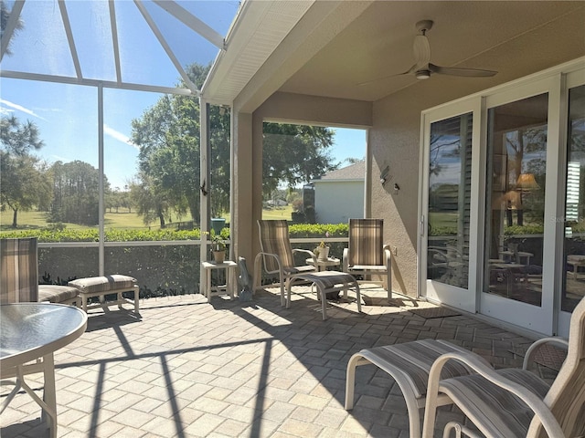 sunroom / solarium featuring ceiling fan