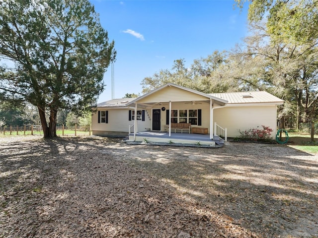 view of front of house with metal roof and a ceiling fan