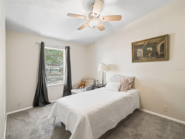 carpeted bedroom featuring a ceiling fan, vaulted ceiling, a textured ceiling, and baseboards